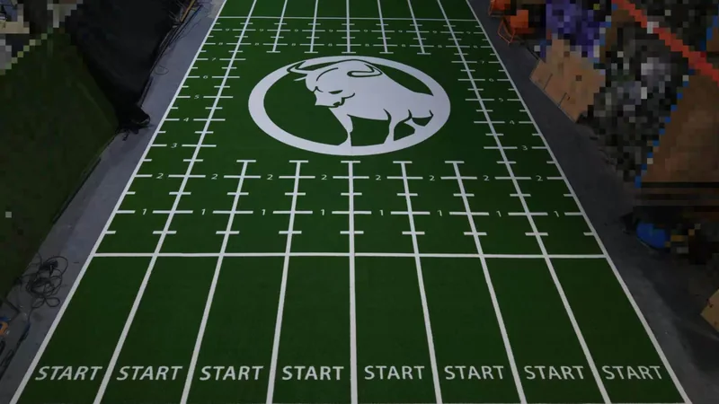 Finished custom gym turf with a large logo and multiple marked training lanes
