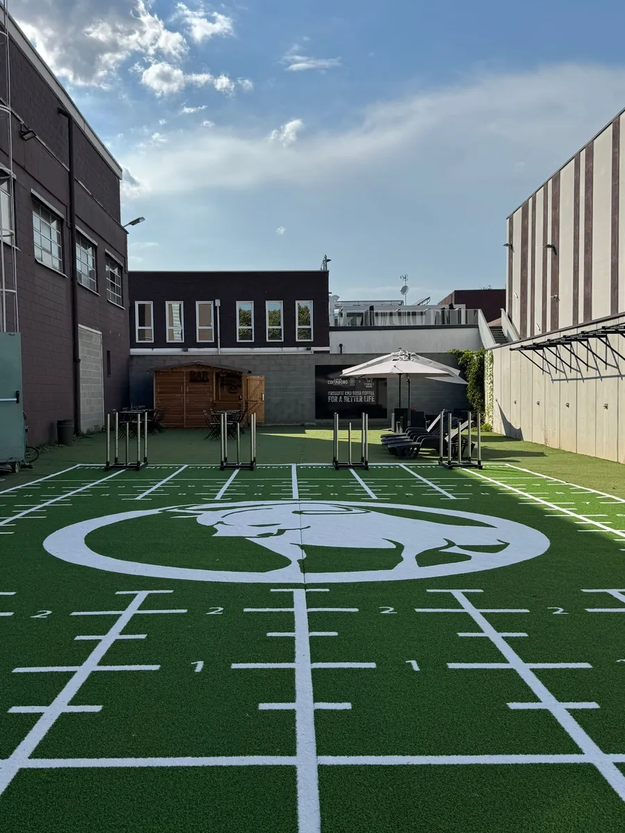 Installed custom training turf with branded lanes inside a commercial fitness facility