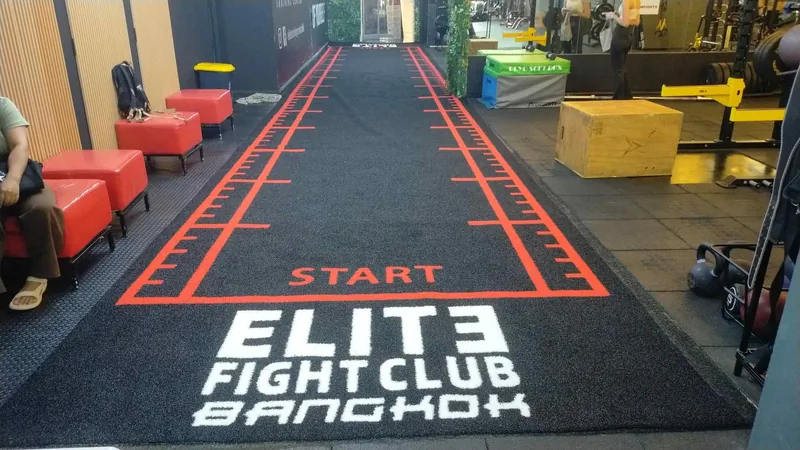 Commercial gym with a custom low-pile turf lane for sled training