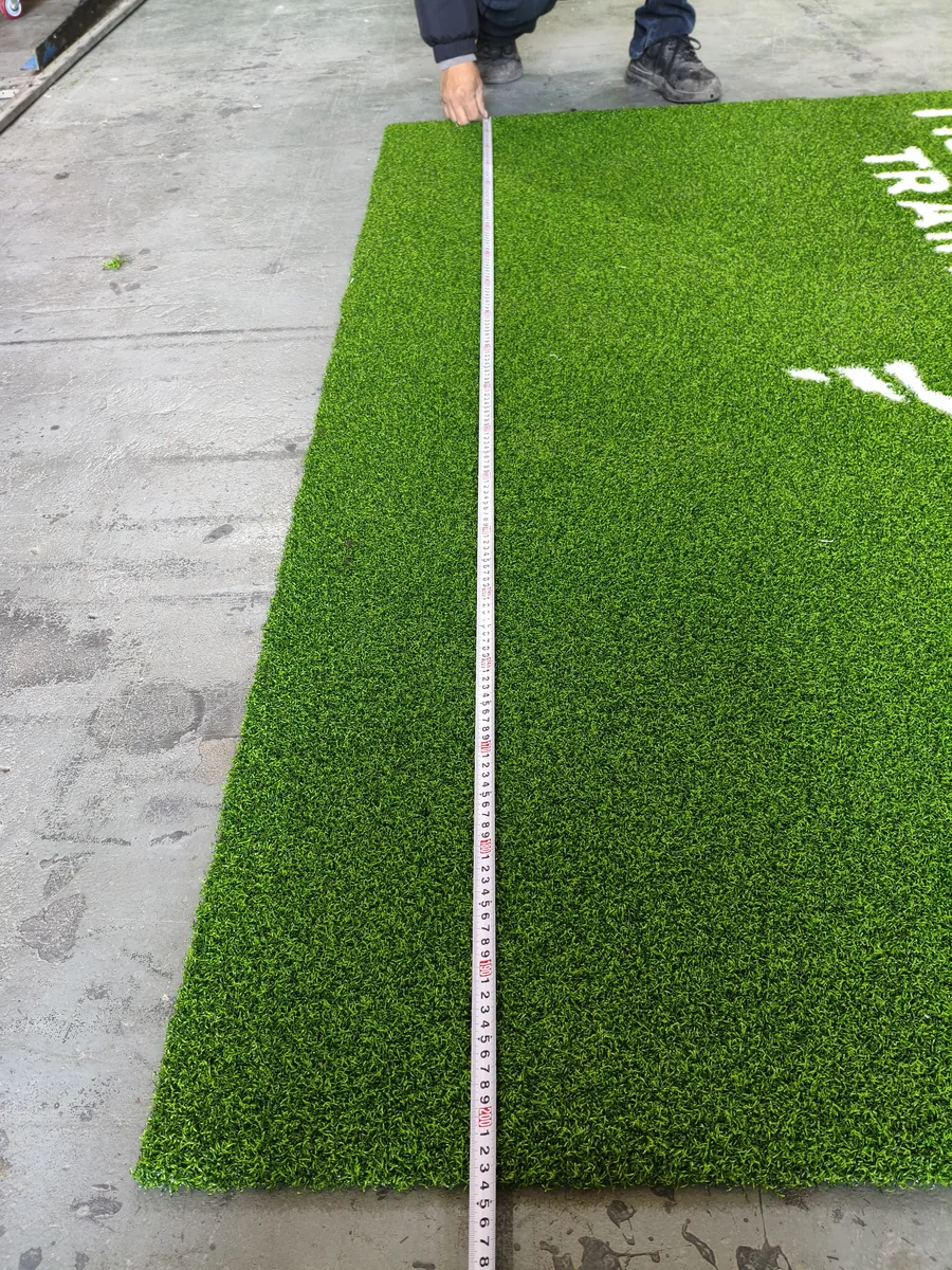 Tape measure confirming the 2m width of the green numbered gym turf