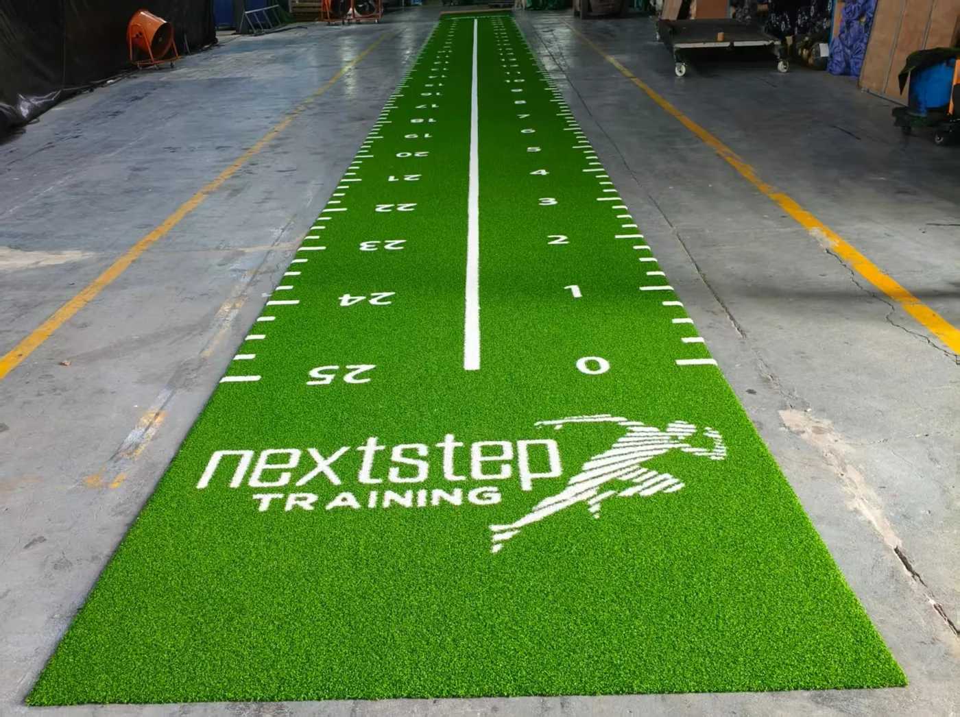 Completed green 30m numbered gym turf roll laid out for factory inspection after production