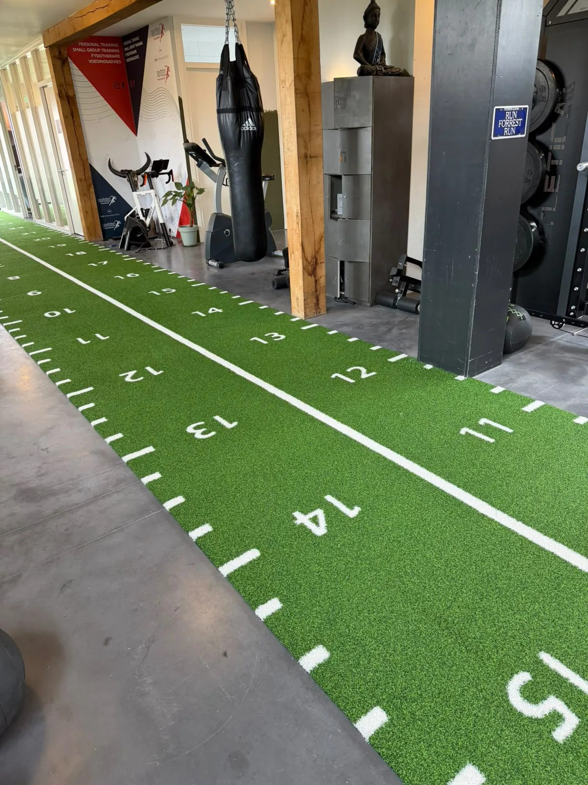 Installed green functional training turf beside strength and conditioning equipment