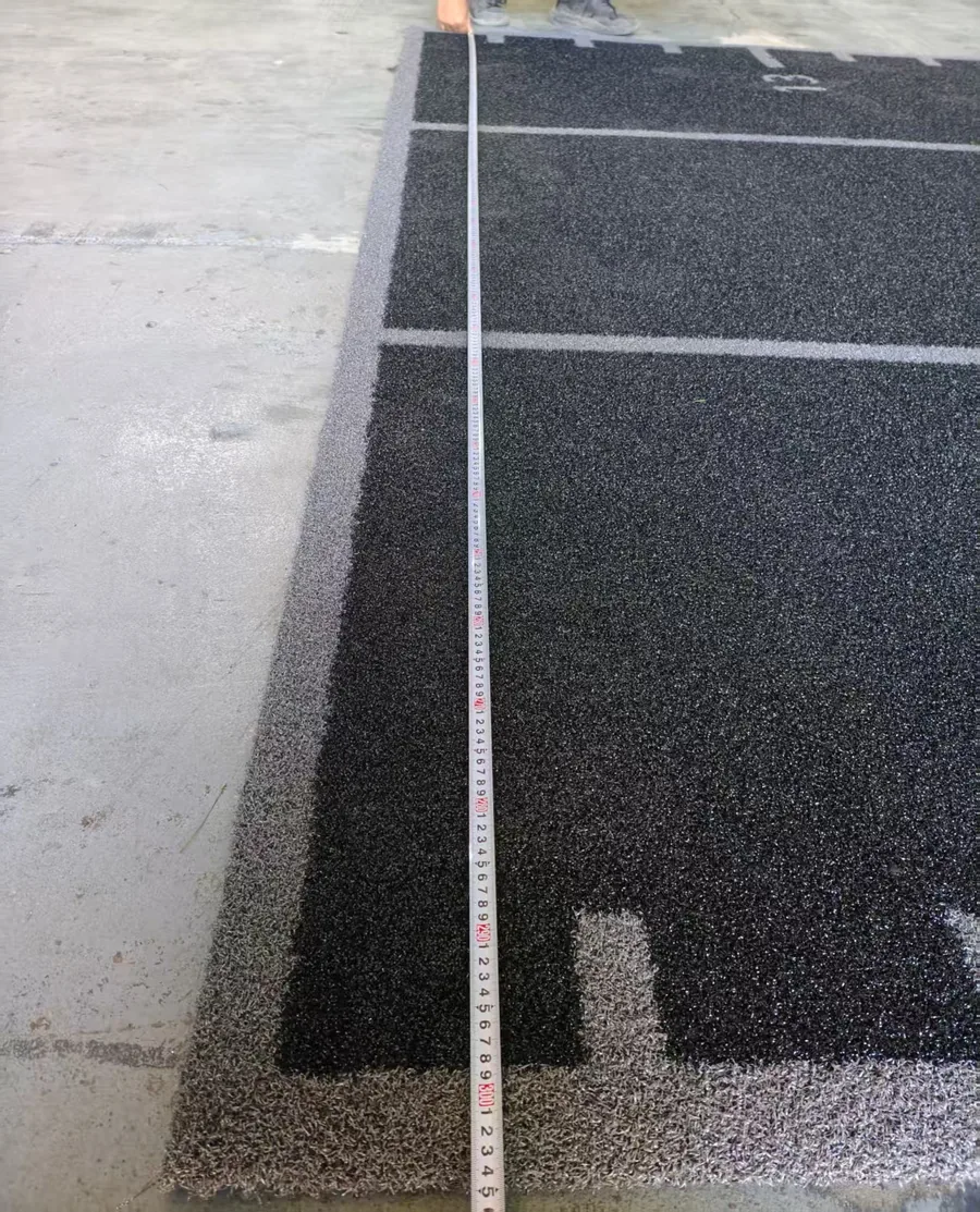 Tape measure confirming the 3m width of the black branded gym turf